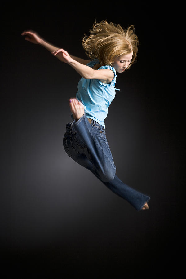 Young woman jumping Photograph by Digital Vision