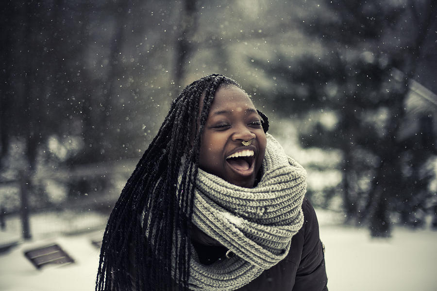 Young woman laughing while its snowing outside Photograph by Moazzam Ali Brohi