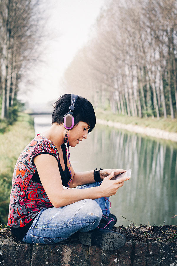 Young woman listen music using headphones Photograph by PJPhoto69