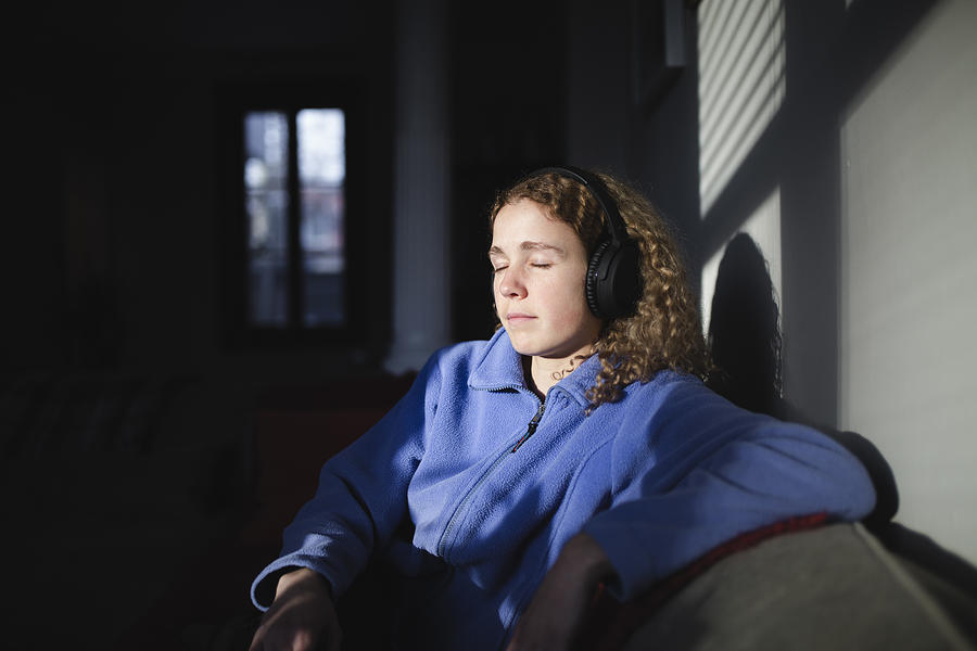 Young woman listening music with headphones Photograph by Linda Raymond