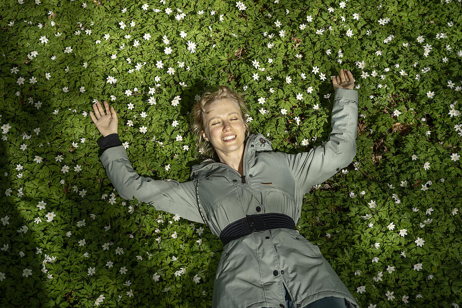 Young woman lying in the forest floor Photograph by Bo Tornvig