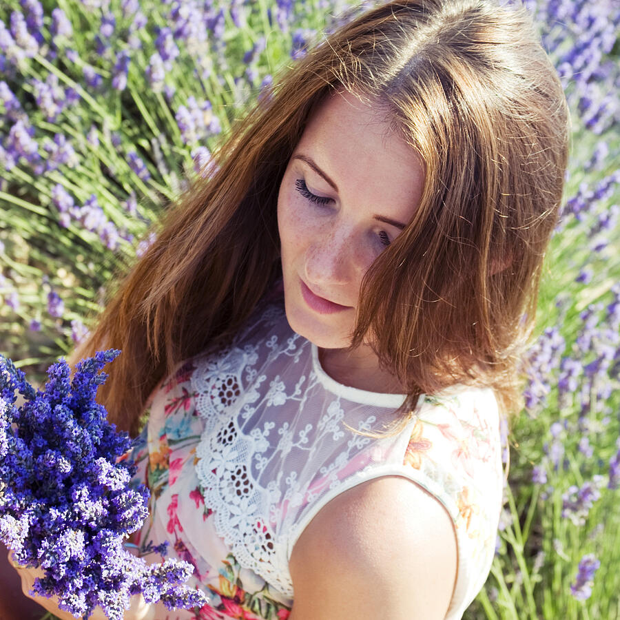 Young woman on a meadow with lavender flowers Photograph by SurkovDimitri