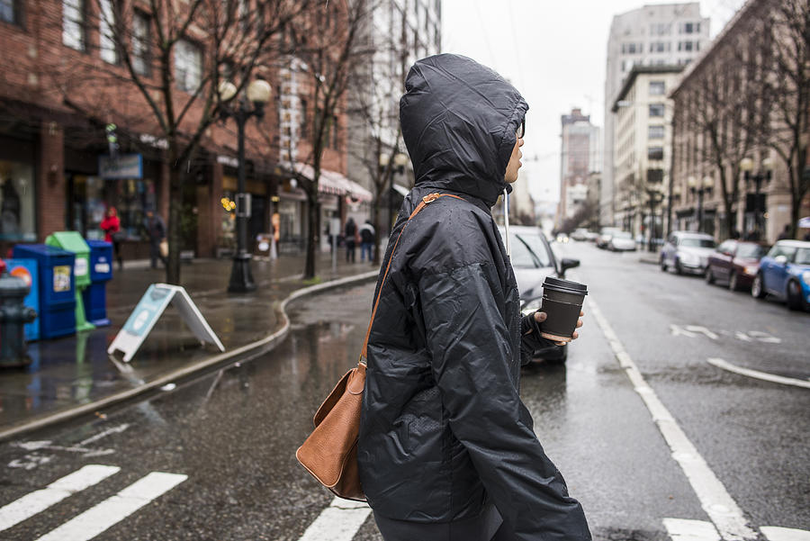 Young woman on rainy pedestrian crossing, Seattle, Washington State, USA Photograph by Rosanna U