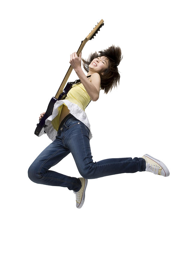 Young woman playing an electric guitar Photograph by Lane Oatey
