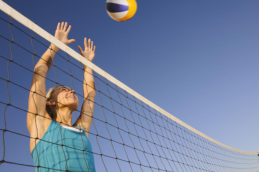 Young woman playing beach volleyball Photograph by Johner Images