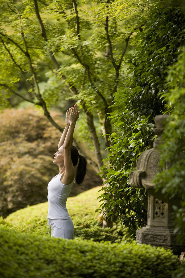 Young woman practicing yoga in Japanese garden Photograph by John Giustina