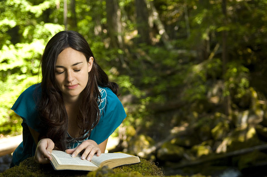 Young woman reading bible by stream Photograph by Jacob D Gregory