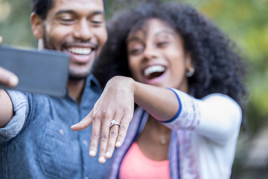 Young woman shows off engagement ring Photograph by SDI Productions