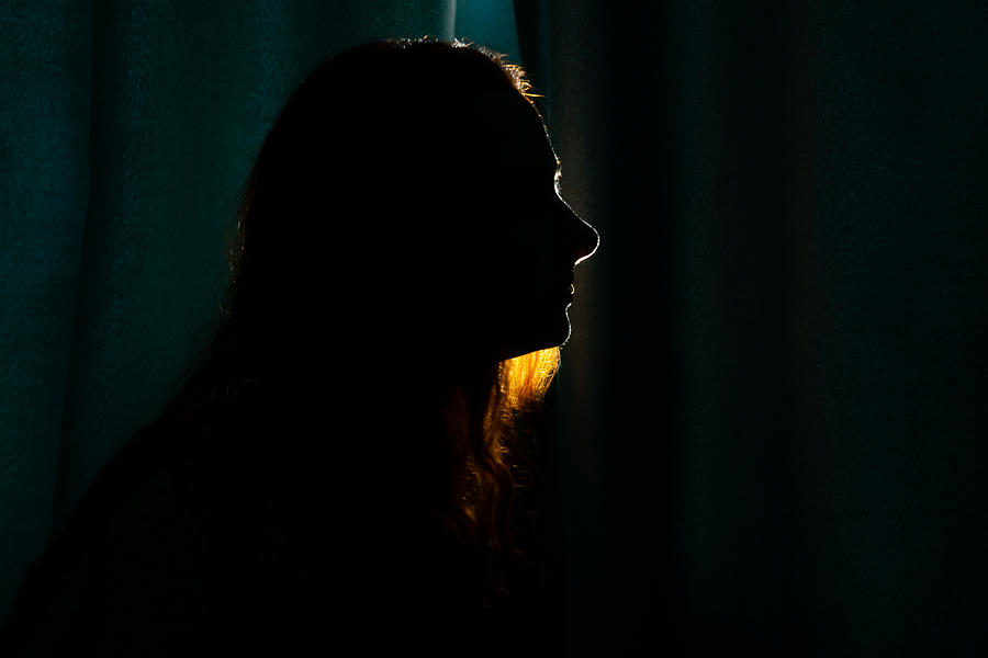Young woman silhouette in dark. Photograph by Tatiana Maksimova