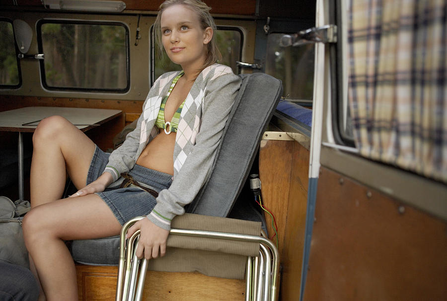 Young Woman Sitting on a Bench in a Motor Home Photograph by Dylan Ellis