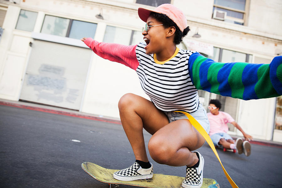Young woman skateboarding Photograph by Stephen Zeigler