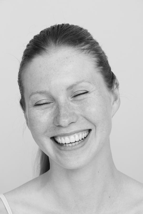 Young woman smiling, eyes closed, portrait Photograph by Pando Hall