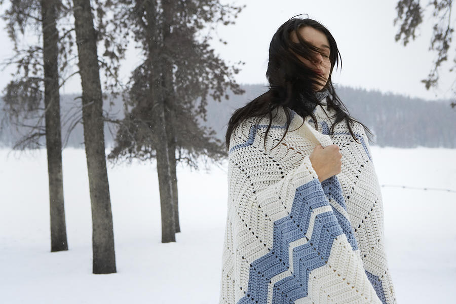 Young woman standing in snow, eyes closed Photograph by Thomas Northcut
