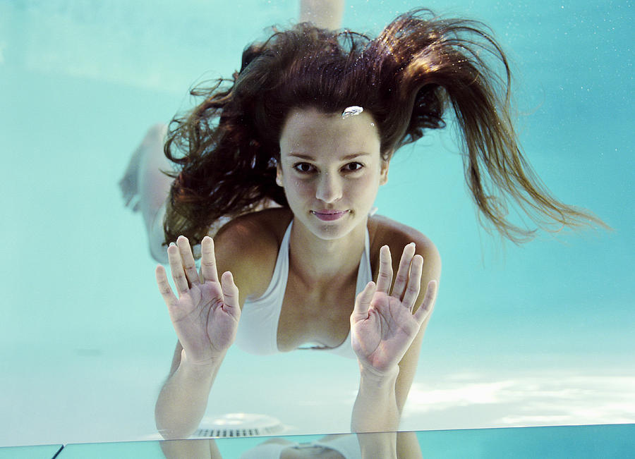 Young woman swimming  underwater Photograph by Siri Stafford