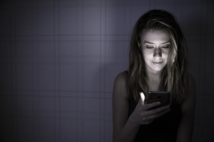 Young Woman Texting On Smartphone At Home Bedroom At Night Photograph by Ljubaphoto