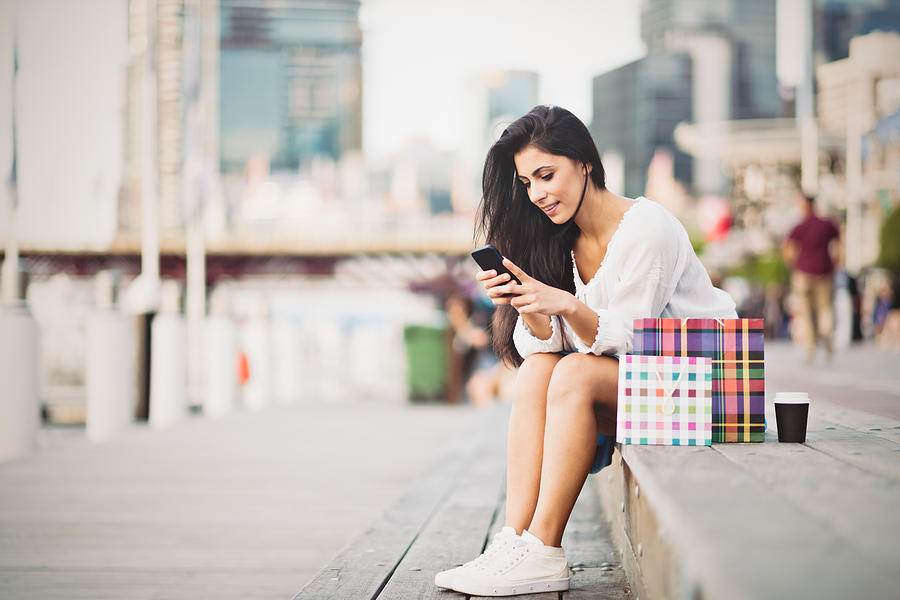 Young woman typing a message on smart phone Photograph by LaraBelova