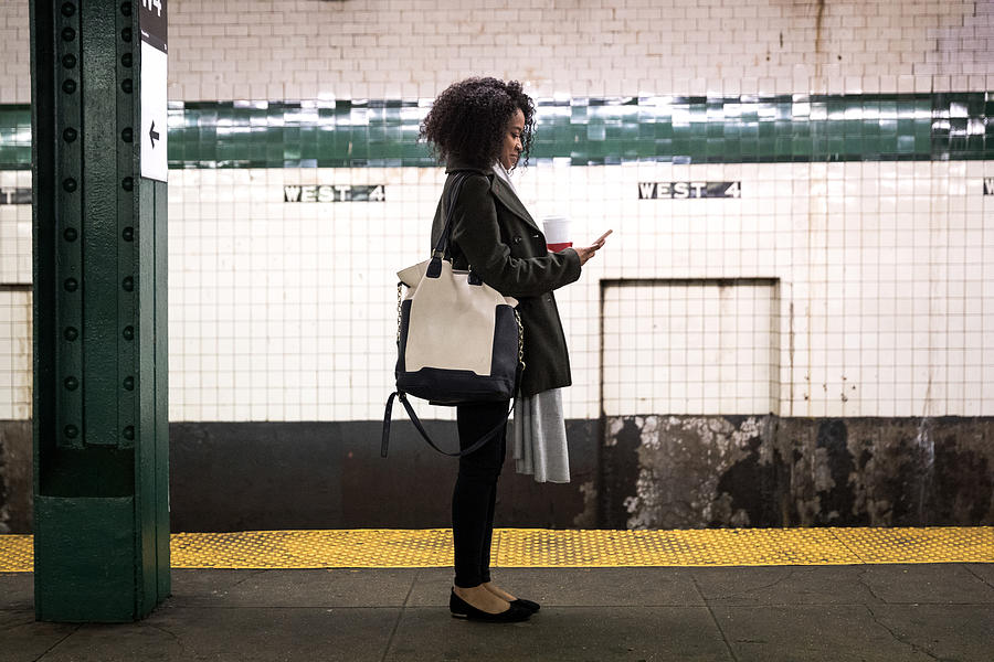 Young woman waiting for the subway train in New York Photograph by LeoPatrizi
