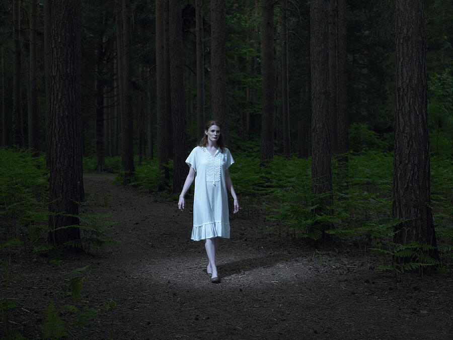 Young woman walking in forest Photograph by Michael Blann
