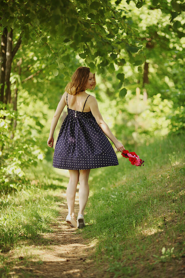 Young woman walking in fresh spring greenery Photograph by Ramune Golysenkiene