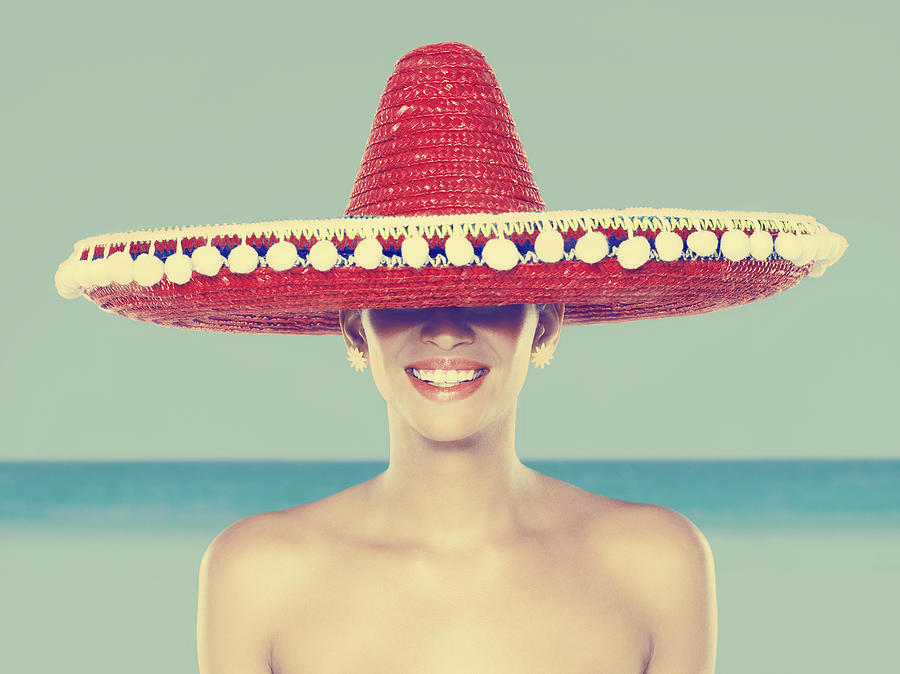 Young woman wearing red sombrero Photograph by Image Source