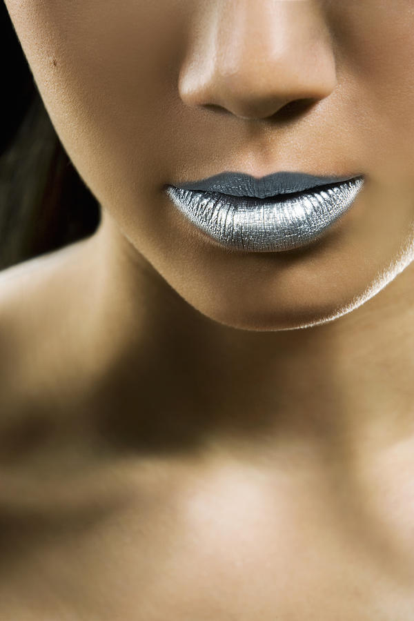 Young woman wearing silver lipstick, mid section Photograph by Scott Kleinman