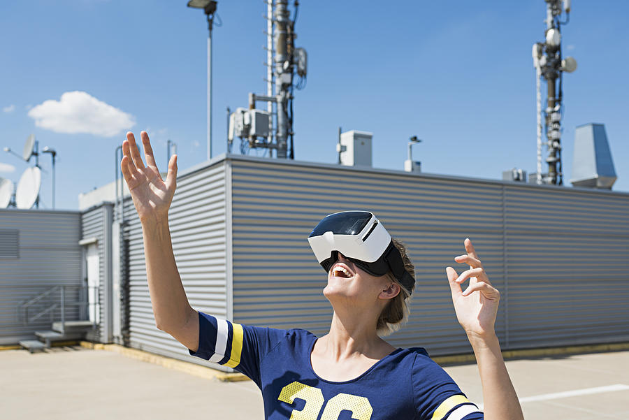 young woman wearing VR Glasses at rooftop Photograph by Joos Mind