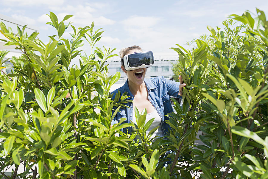 young woman wearing VR Glasses exploring plants Photograph by Joos Mind
