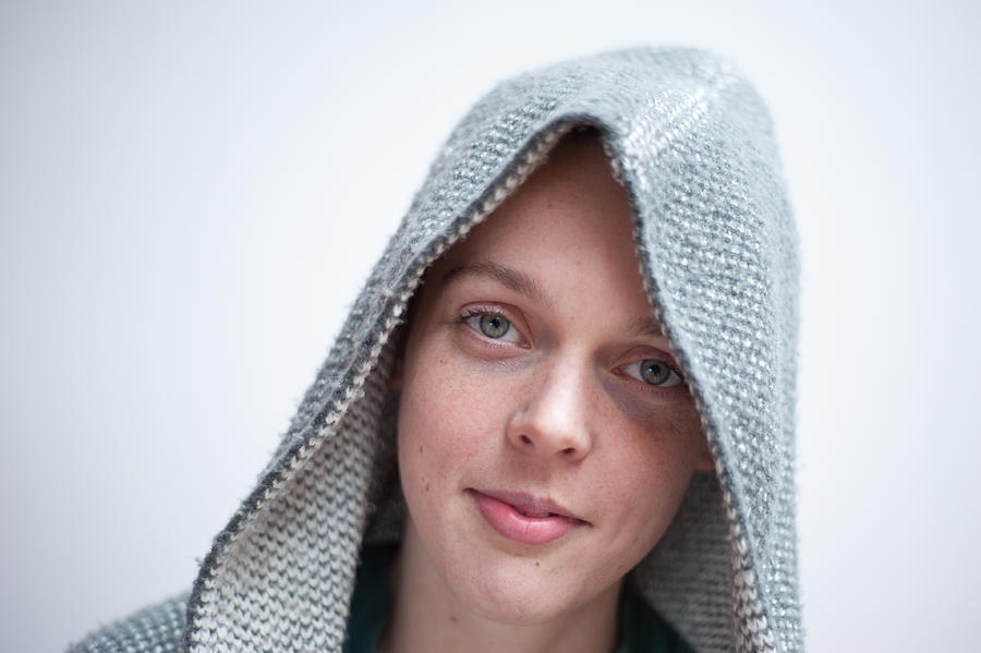 Young woman wearing woolen hoodie Photograph by Lucy Lambriex