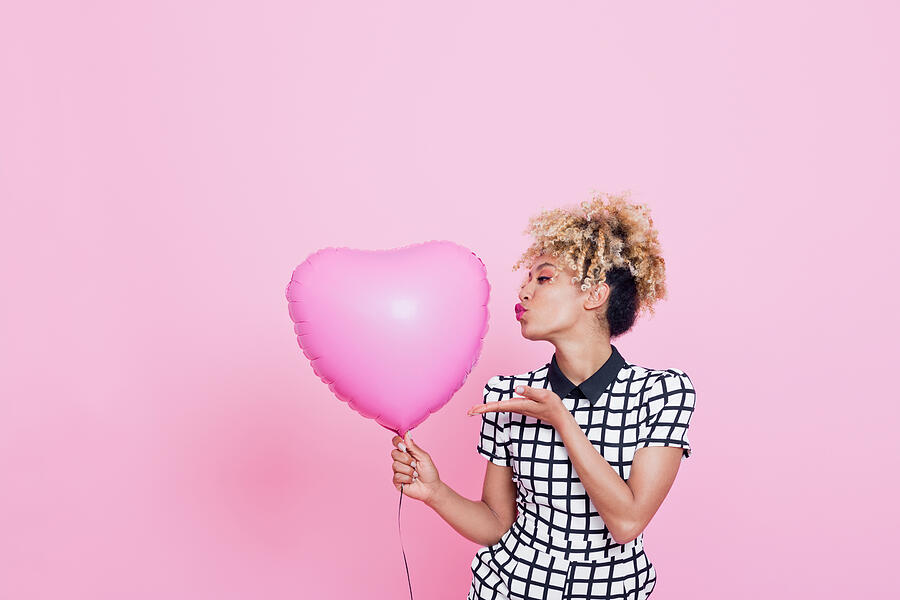 Young woman with big pink heart Photograph by Izusek