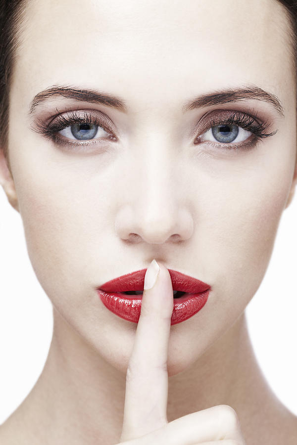 Young Woman With Finger On Lips Photograph by Stephen Smith