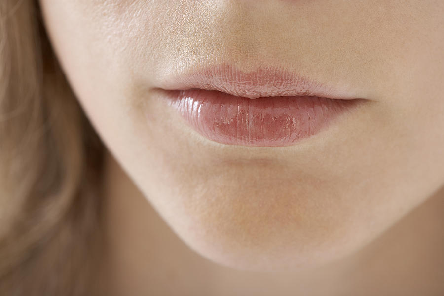 Young womans lips, close-up Photograph by Feliz Aggelos