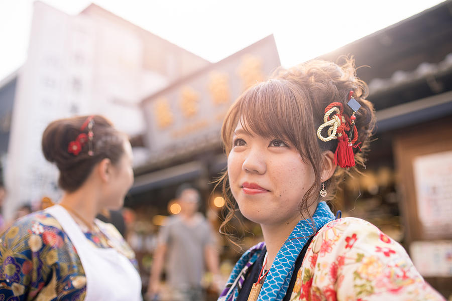 Young women in Japanese matsuri outfit standing on street Photograph by Satoshi-K