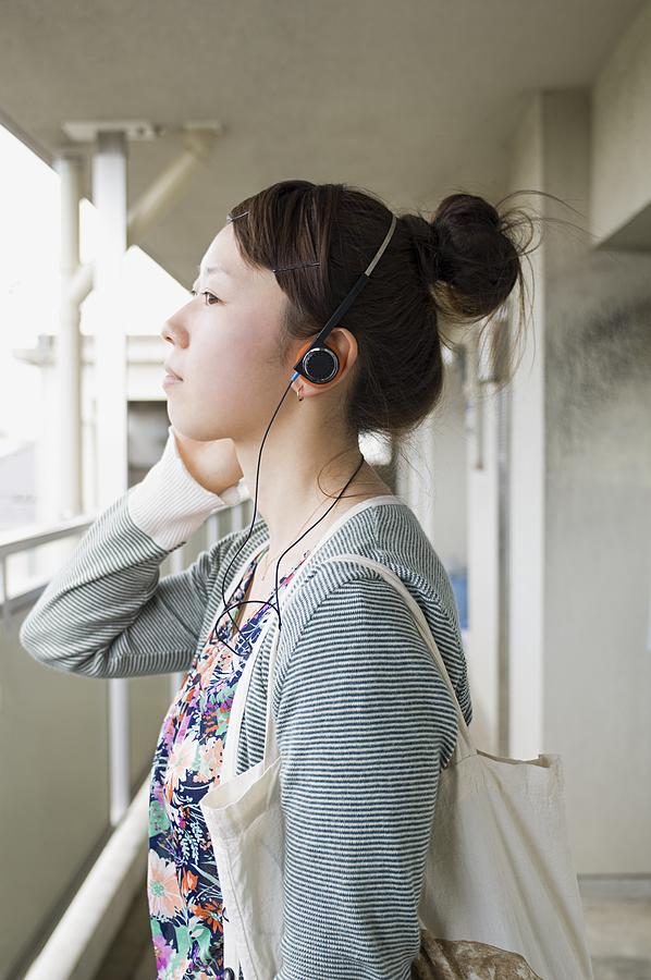 Young women wearing headphones Photograph by Image Source