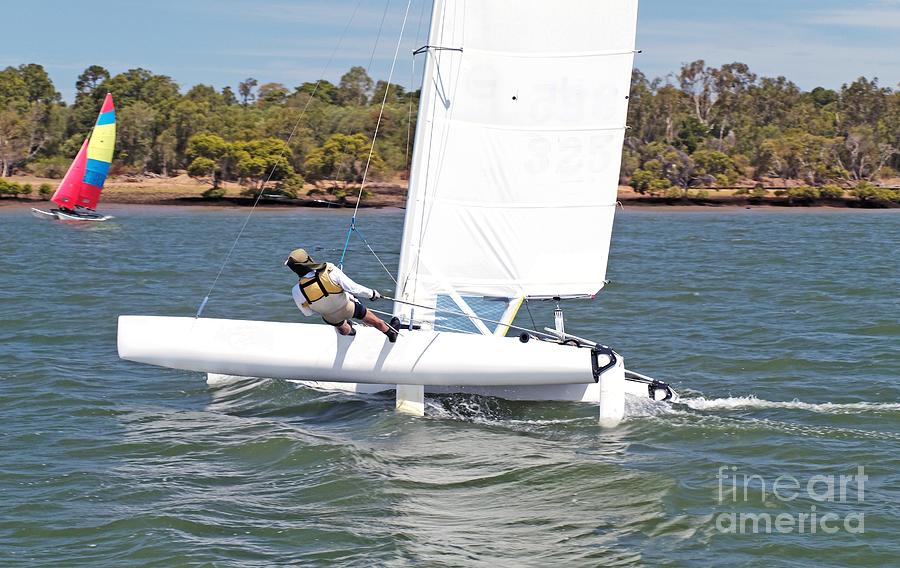 Youth Sailing small catamaran boat with a white sail, Bundaberg, Photograph by Geoff Childs