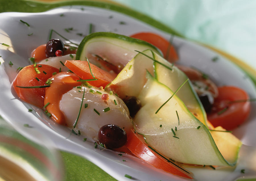 Zucchini, tomato and scallop dish with herbs, close-up Photograph by Isabelle Rozenbaum & Frederic Cirou