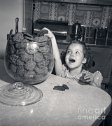 Girl With Hand In Cookie Jar, C.1950s Photograph by Debrocke/ClassicStock