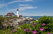 Lighthouse with Rocks on Shore Photograph by Bill Bachmann and Photo Researchers