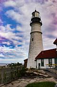 Puffy white clouds above Portland Lighthouse Photograph by Jeff Folger
