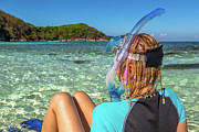 Snorkeler relaxing on tropical beach Photograph by Benny Marty