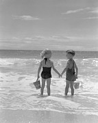 Boy And Girl Standing On Beach, Holding Photograph by H. Armstrong Roberts