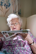 Care Home Resident Reading Newspaper Photograph by Science Photo Library