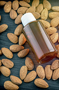 Essential Almond Oil On A Wooden Table Photograph by Science Photo Library
