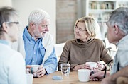 Four Friends Talking In Retirement Home Photograph by Science Photo Library