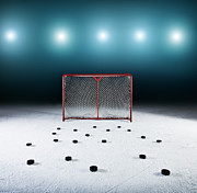 Ice Hockey Goal Surrounded By Pucks Photograph by Robert Decelis Ltd