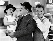 OLIVER HARDY , STAN LAUREL and SPANKY in TIT FOR TAT -1935-. Photograph by Album