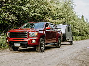 Red Pickup Truck On Dirt Road Hauling Teardrop Camper Trailer Rv Photograph by Cavan Images