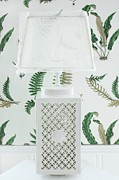 Table Lamp With White Ceramic Base With Ornate Perforated Pattern And Translucent Lampshade Against Fern-patterned Wallpaper Photograph by Annette Nordstrom