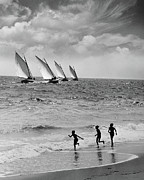 Three Boys Running Along Beach Photograph by Stockbyte