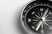 A black and silver compass on a white background Photograph by Peepo