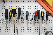 A collection of screwdrivers hanging from a pegboard Photograph by Melinda Podor